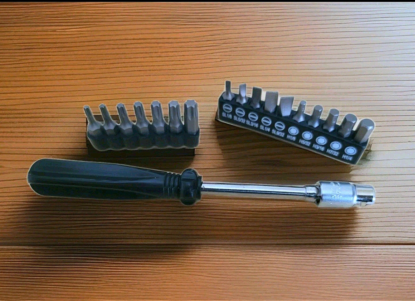 Ratchet screwdriver bit set , including various flat and hexagonal bits.